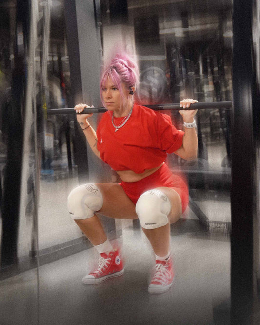 woman doing slow squats with uppper knee sleeves
