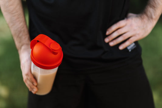 man holding protein shake