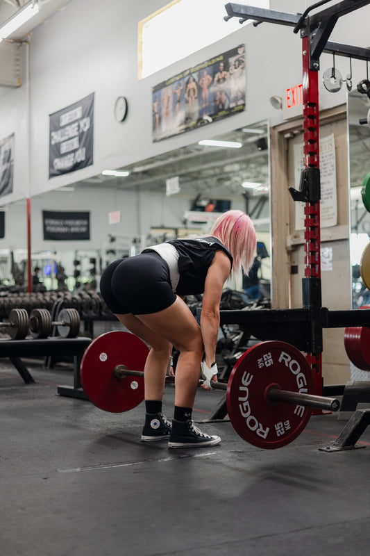 woman doing hamstring exercise wearing uppper lifting gear