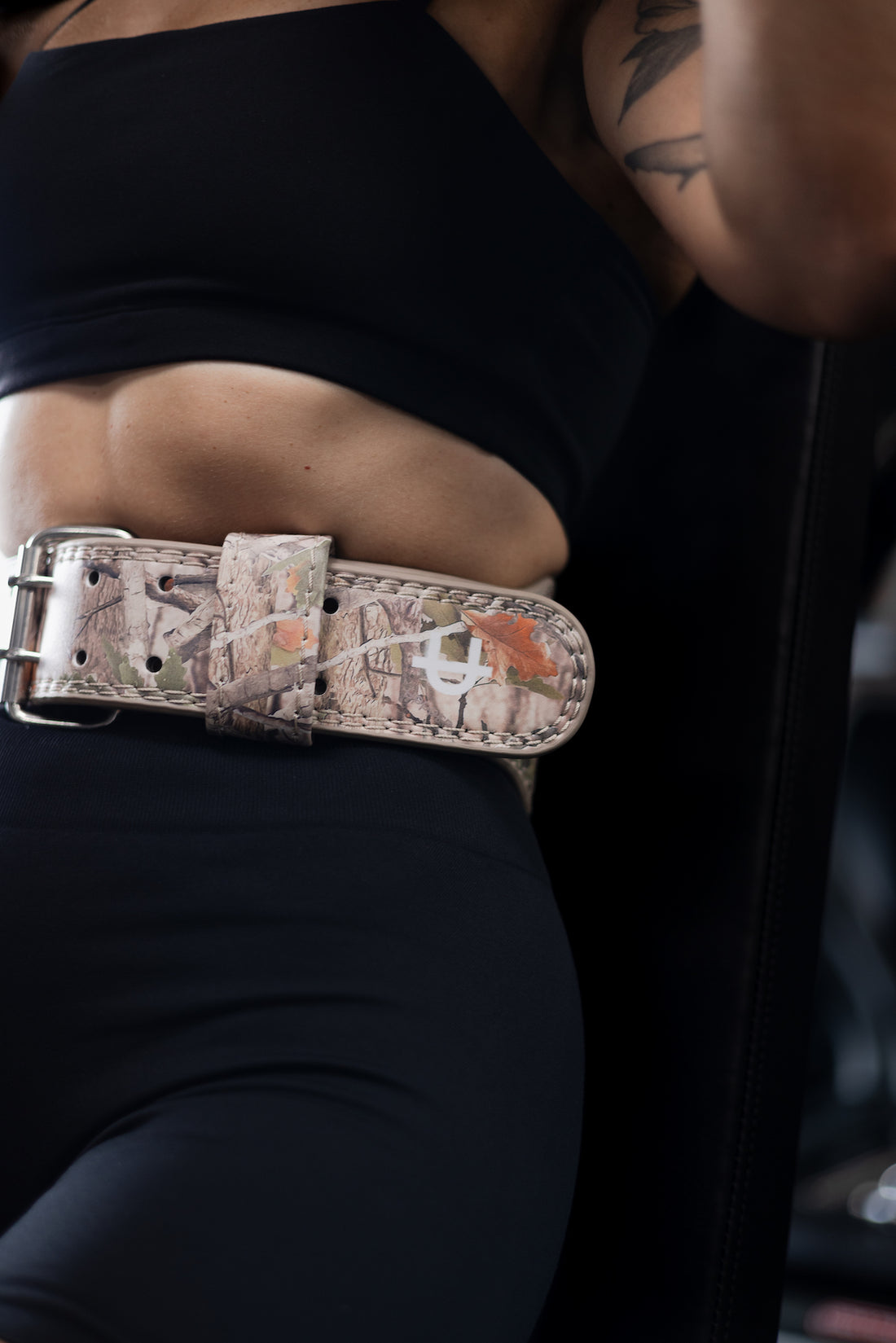 woman wearing a uppper weightlifting belt while lifting