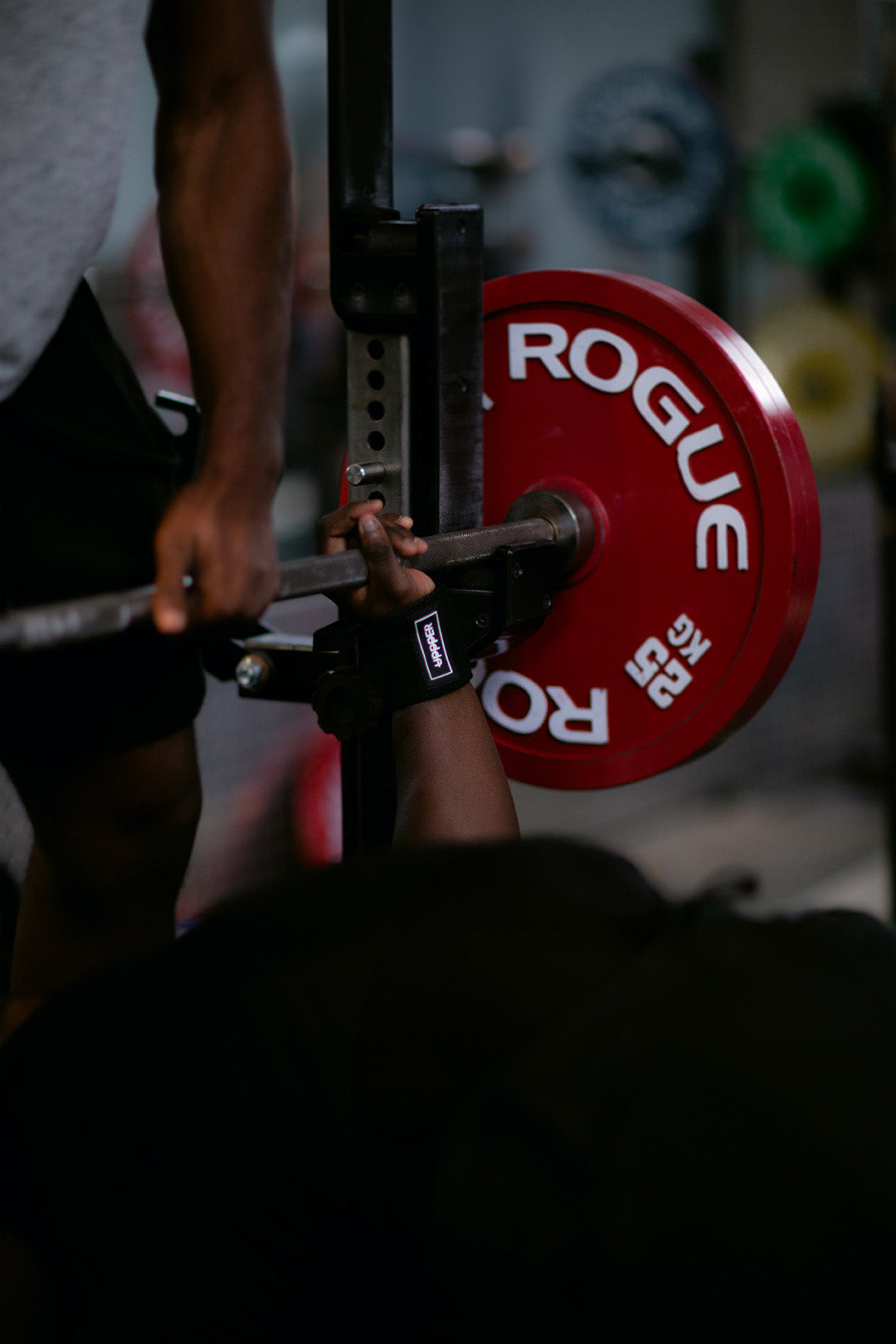 man bench pressing with uppper wrist wraps