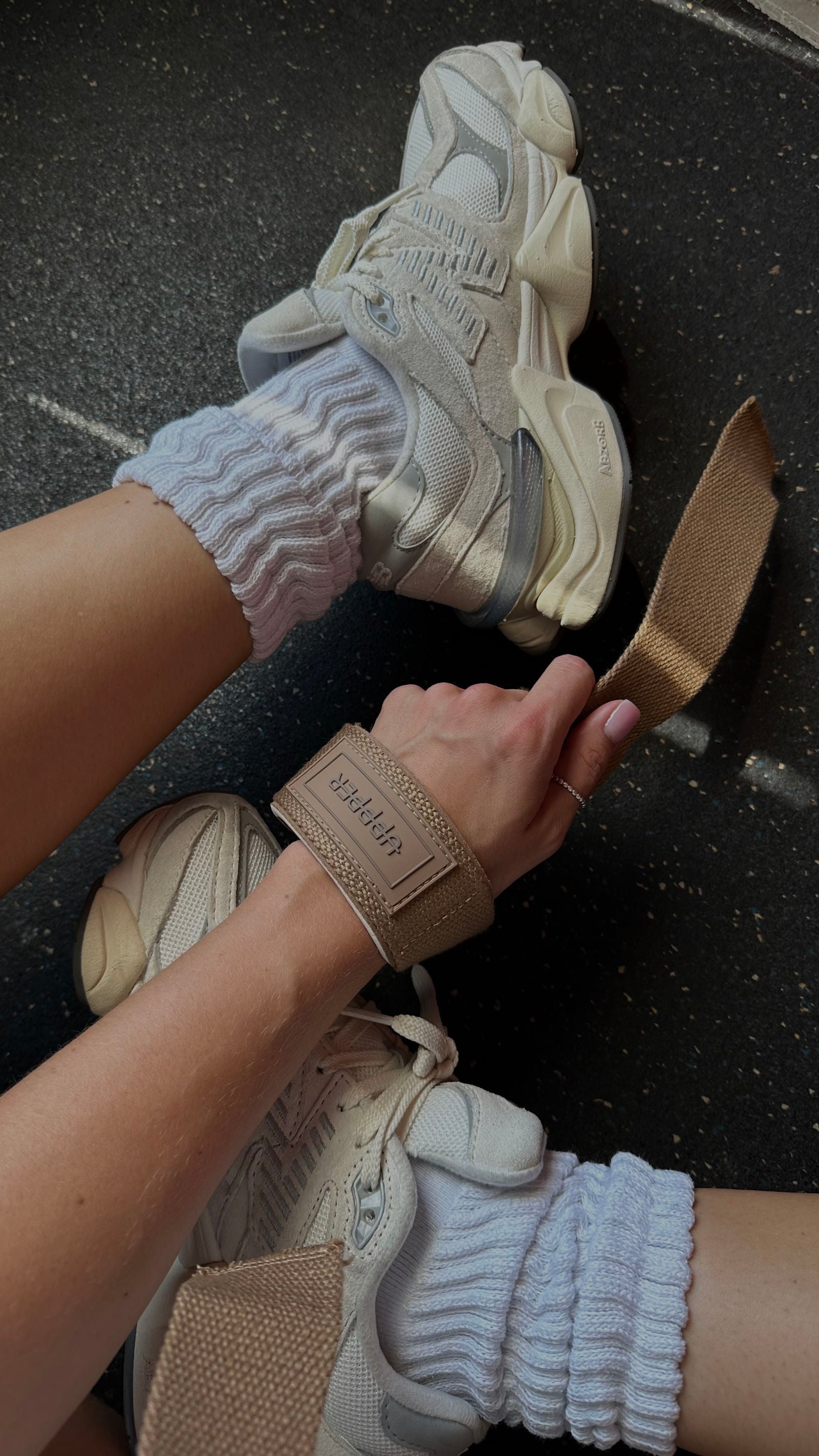 lifestyle photo of mud uppper lifting straps looped on wrist